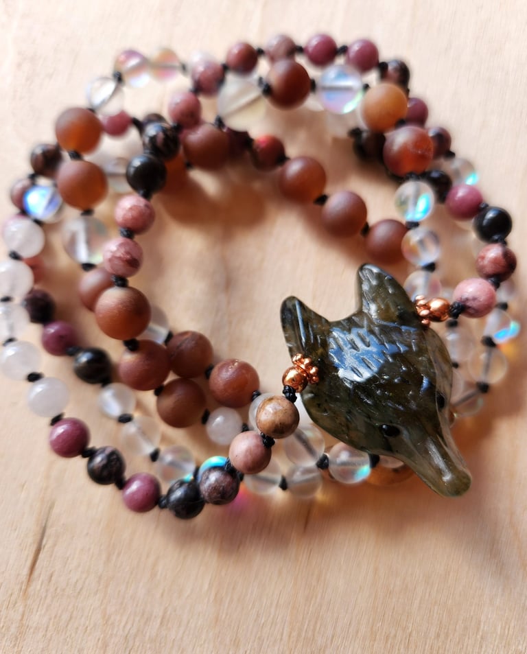 Hand-knotted gemstone mala necklace with 108 beads, created by Tina Medina for spiritual meditation and energy healing