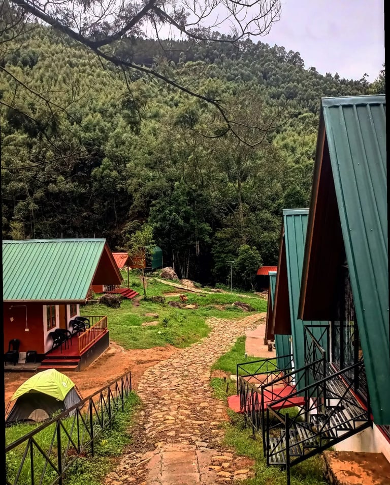a path leading to a small cabin with a view of the mountains