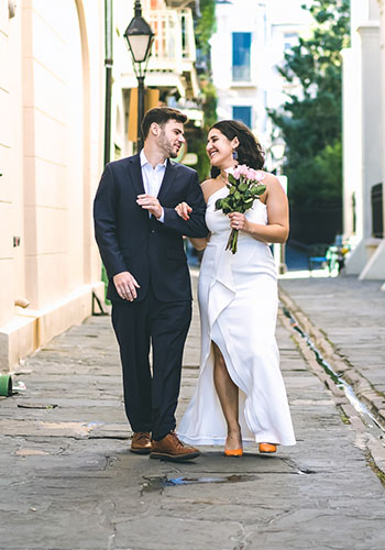 a bride and groom walking down a narrow alley near St Louis cathedral in New Orleans
