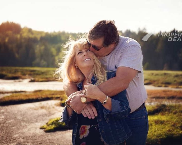 a man and woman embracing in a field