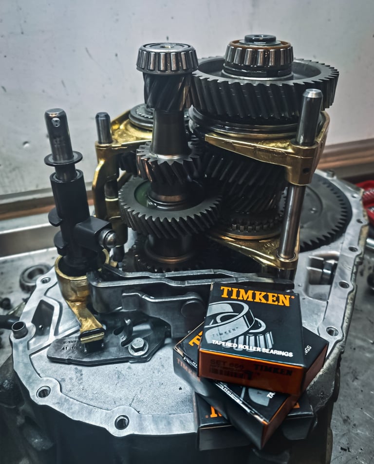 Manual transmission gear assembly with new Timken tapered roller bearings for automotive repair.