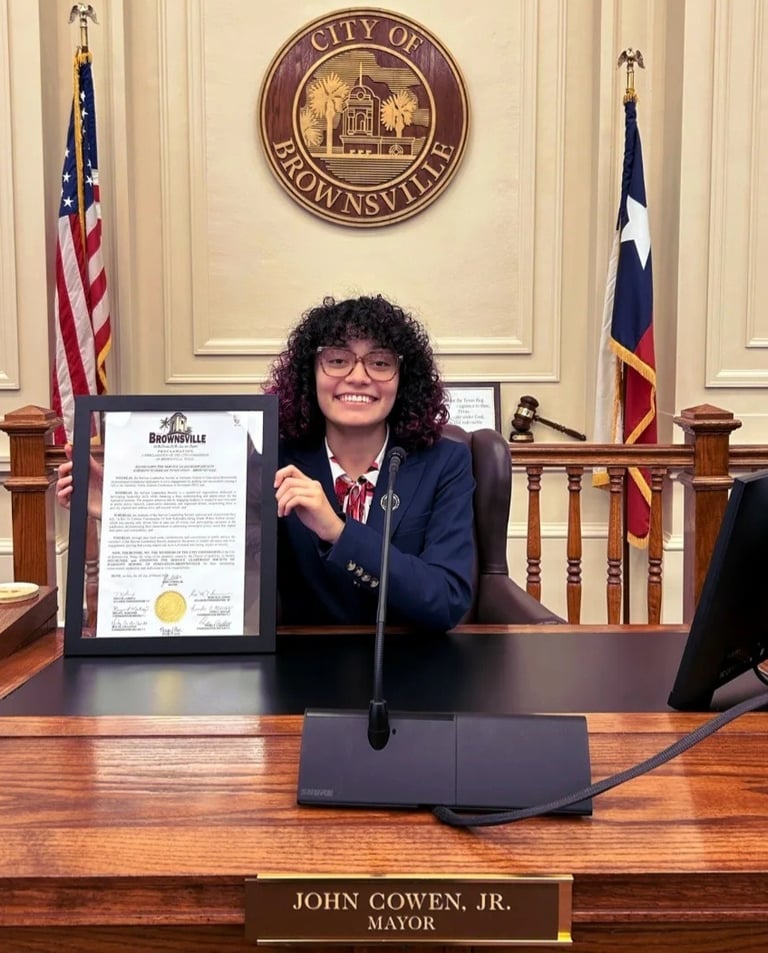 A woman holding a certificate in a court room