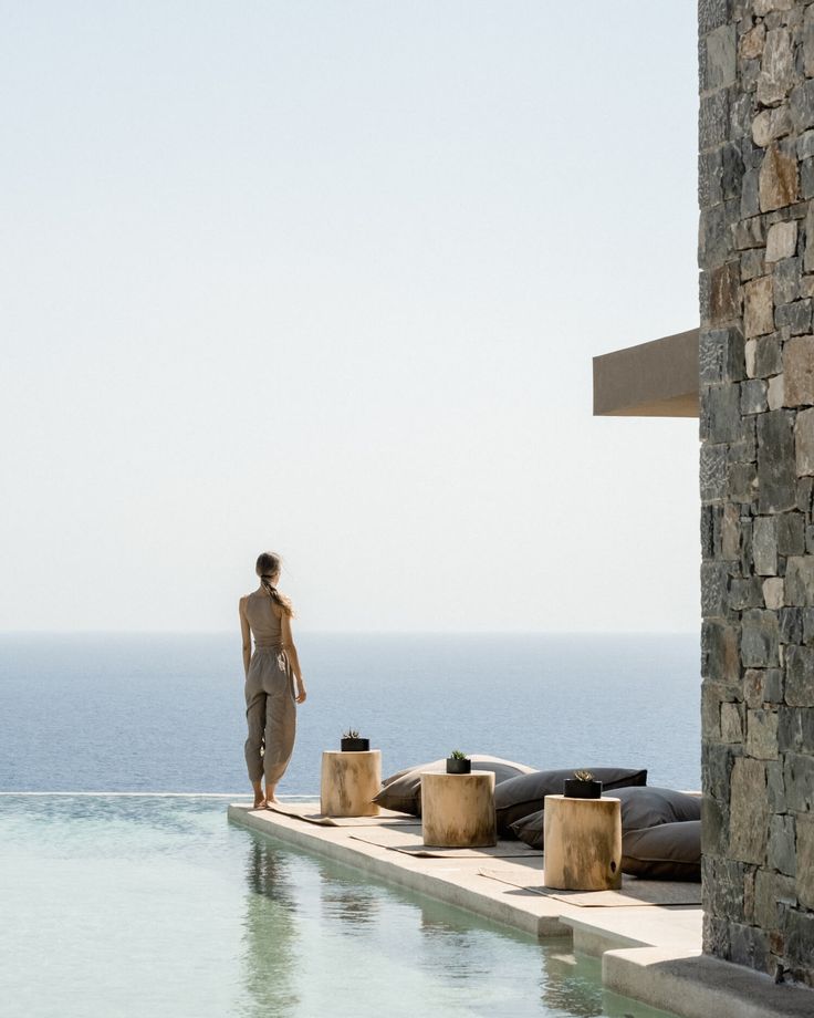 a lady at a wellness hotel standing overlooking a beautiful ocean