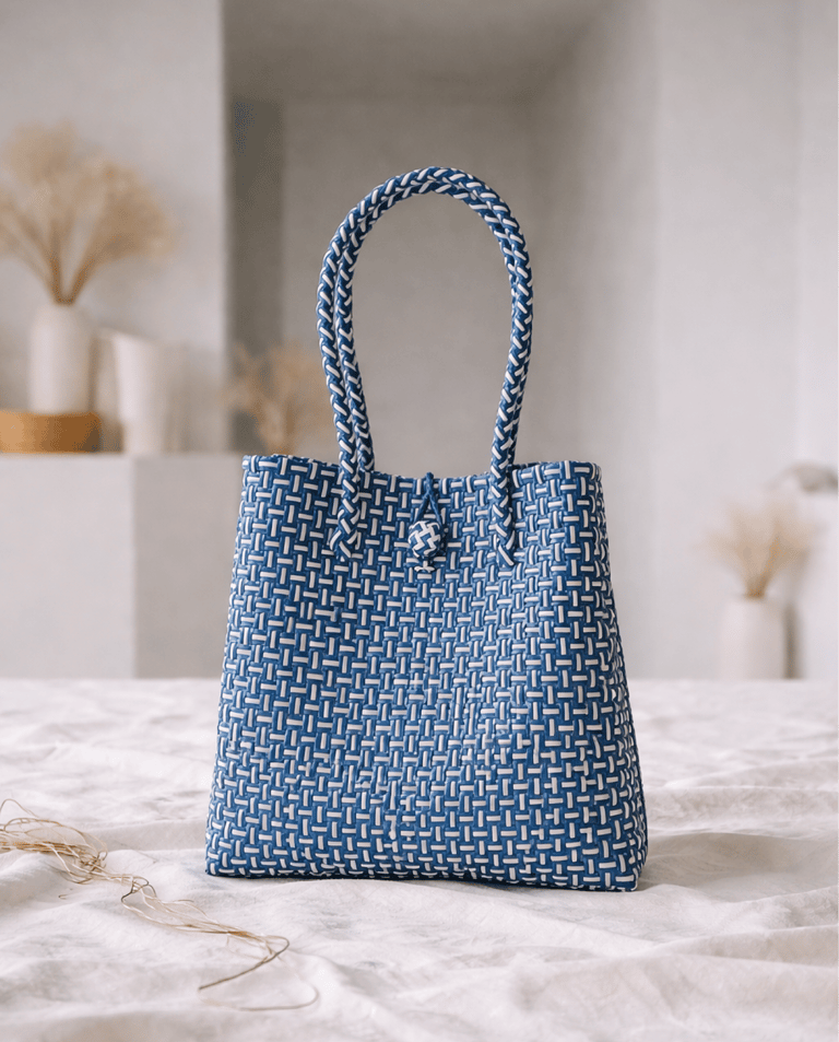 Handwoven blue striped plastic tote bag handmade from recycled materials by Indonesian artisans