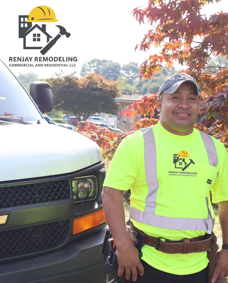 Jay Bravo, founder of Renjay Remodeling, standing by company vehicle in Connecticut