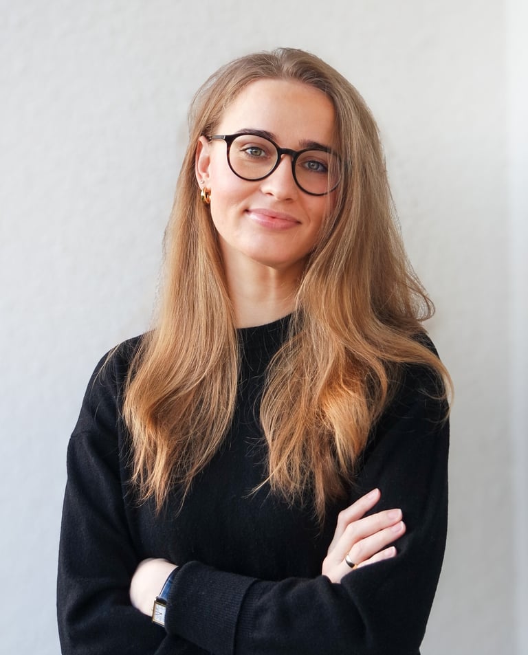 a woman with glasses and a black sweater