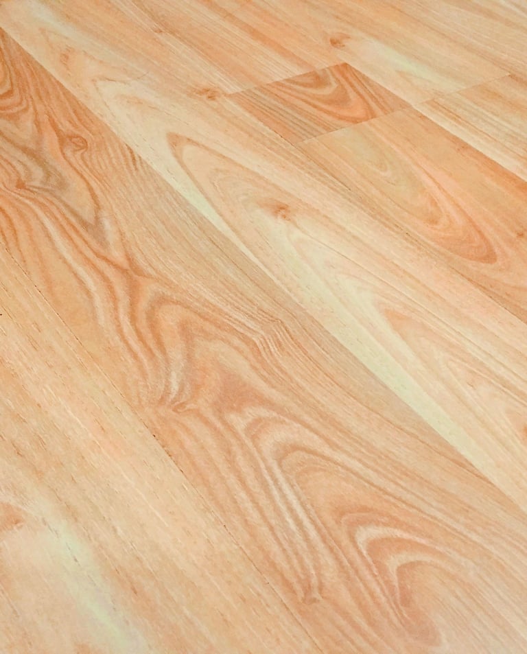 Light brown oak laminate flooring with realistic wood grain texture for home interior design.