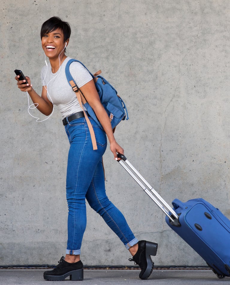 a woman walking down the street with a suitcase