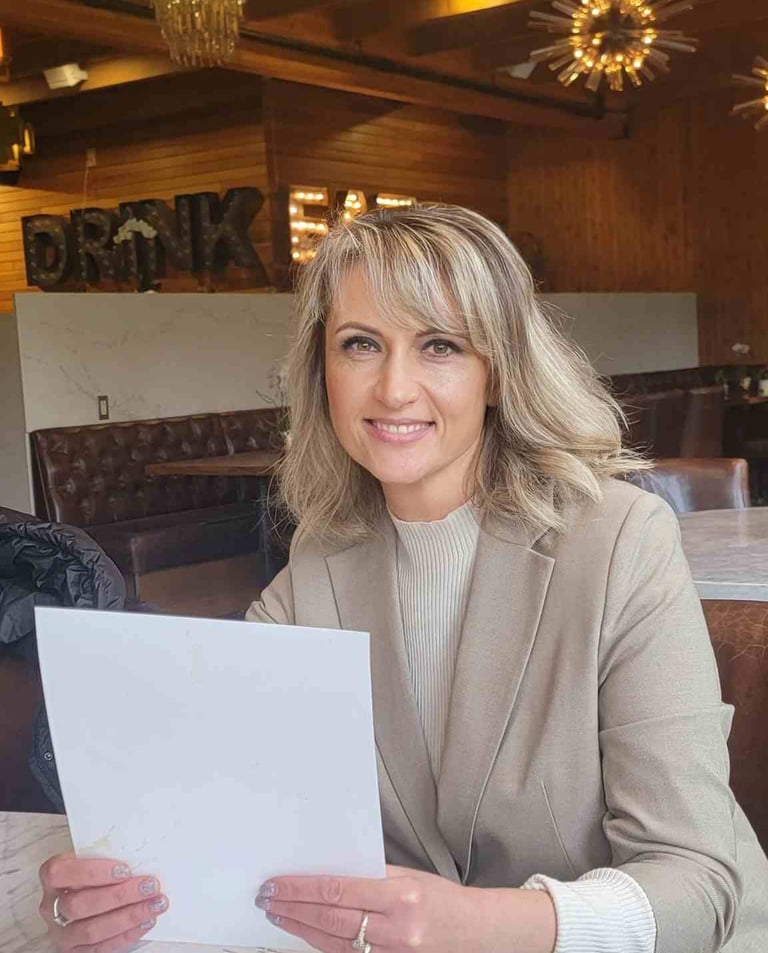 a woman sitting at a table with a piece of paper