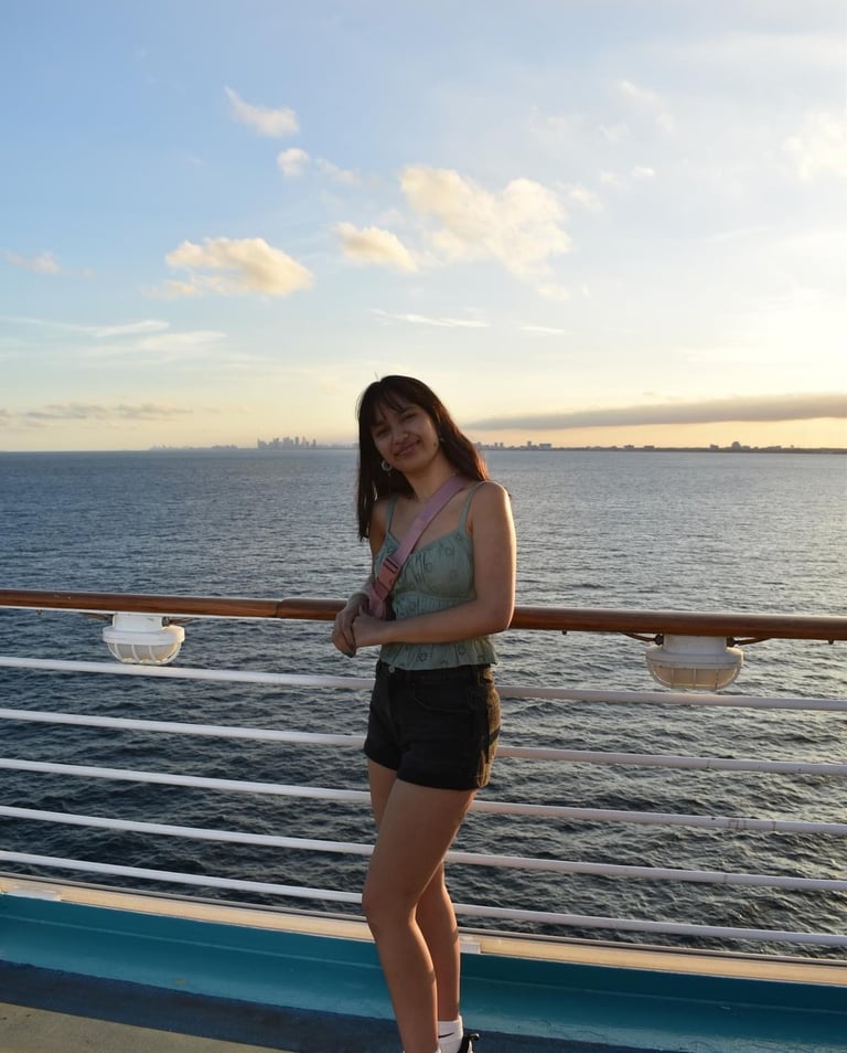 a woman standing on a deck deck of a cruise ship