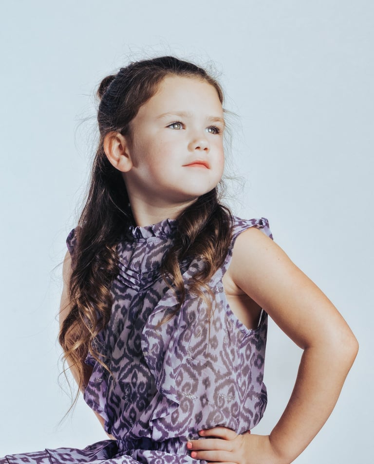 portrait of a young girl in a purple dress with a purple dress
