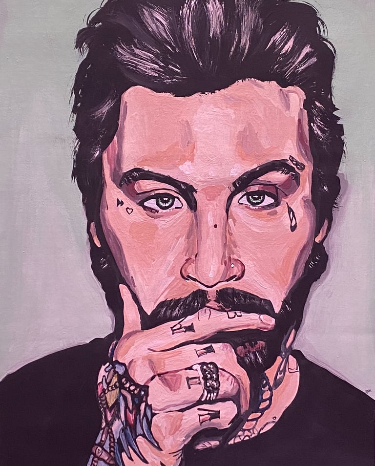 portrait of a white man with his hand by his face