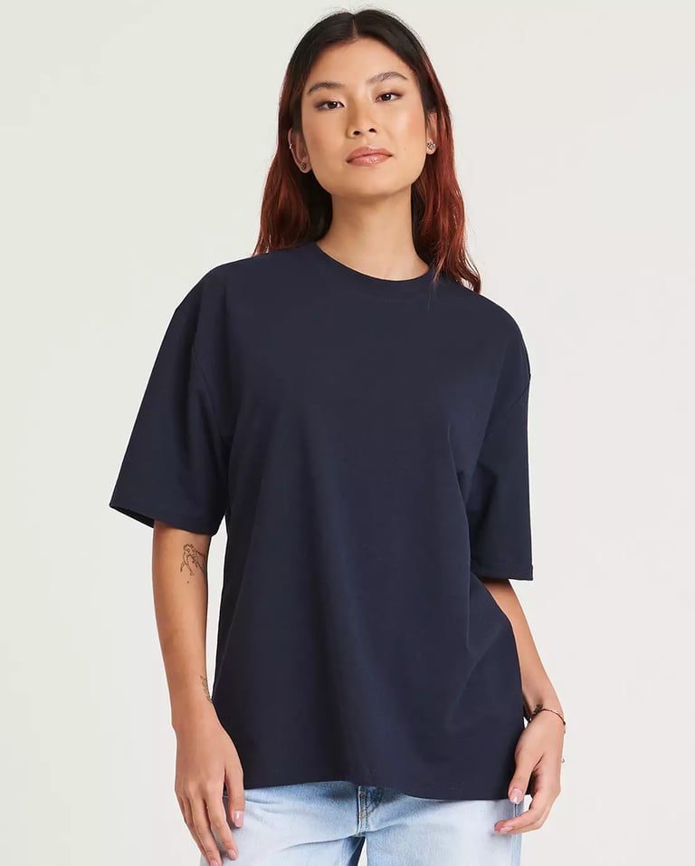 a woman wearing a navt tee - shirt and jeans