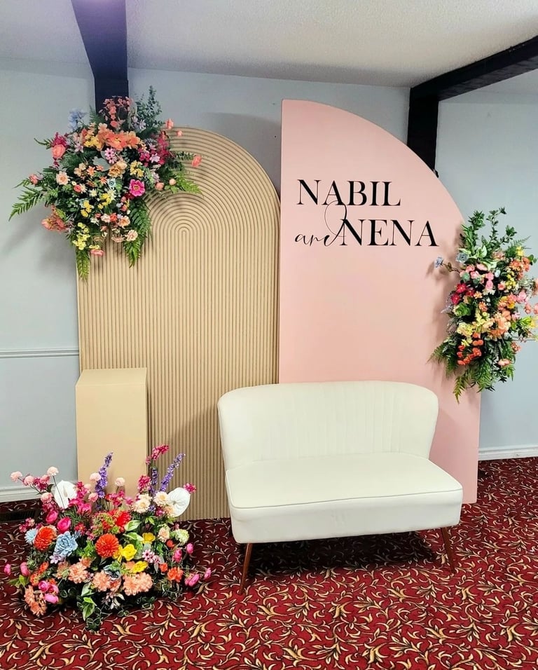 a white couch with a flower arrangement on it