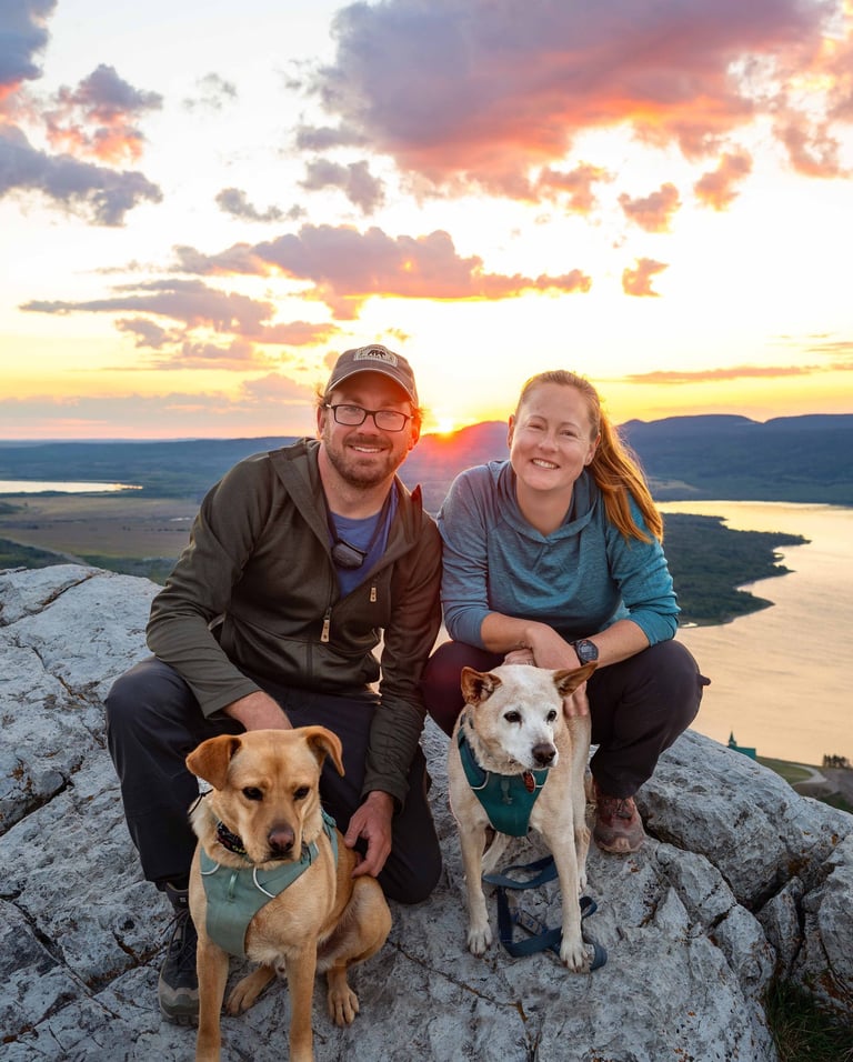 Sunrise on Bear’s Hump with couple and dogs above Upper Waterton Lake.
