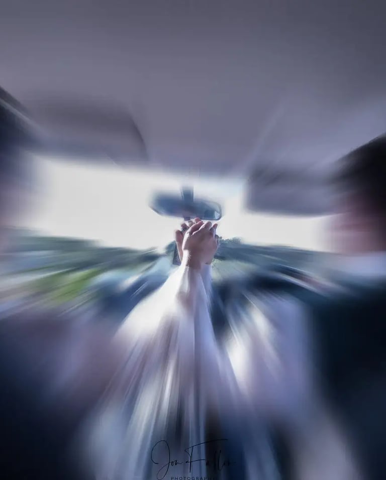 wedding couple holding hands in their car