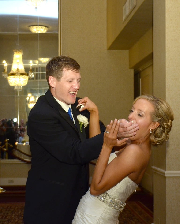 a bride and groom feeding each other a piece of cake