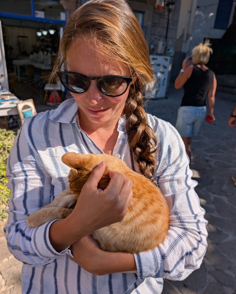 Samantha holding an orange cat on Lesbos island greece
