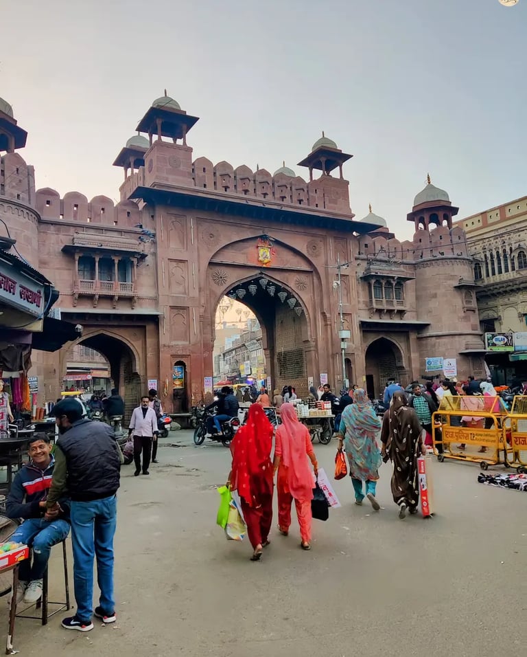 Street view of Kote Gate Bazaar in Bikaner, with traditional shops and bustling local crowds.