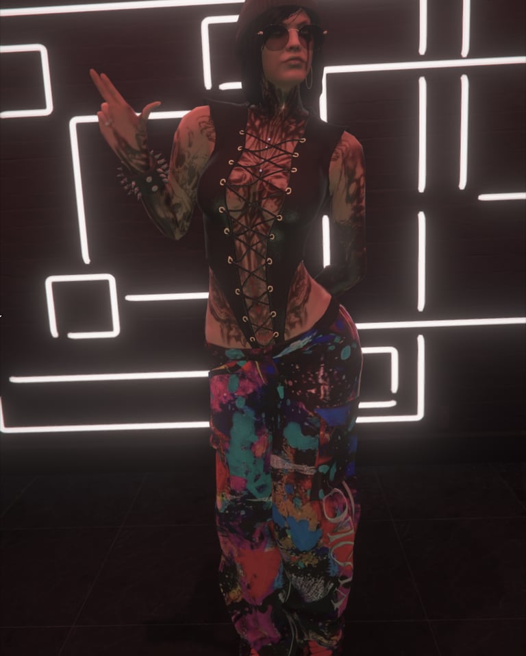 a woman in a colorful outfit standing in front of a neon - lit neon sign