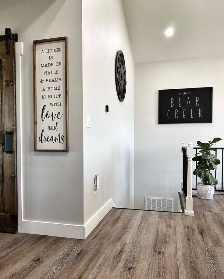 Close-up of baseboard trim installed along hardwood flooring.