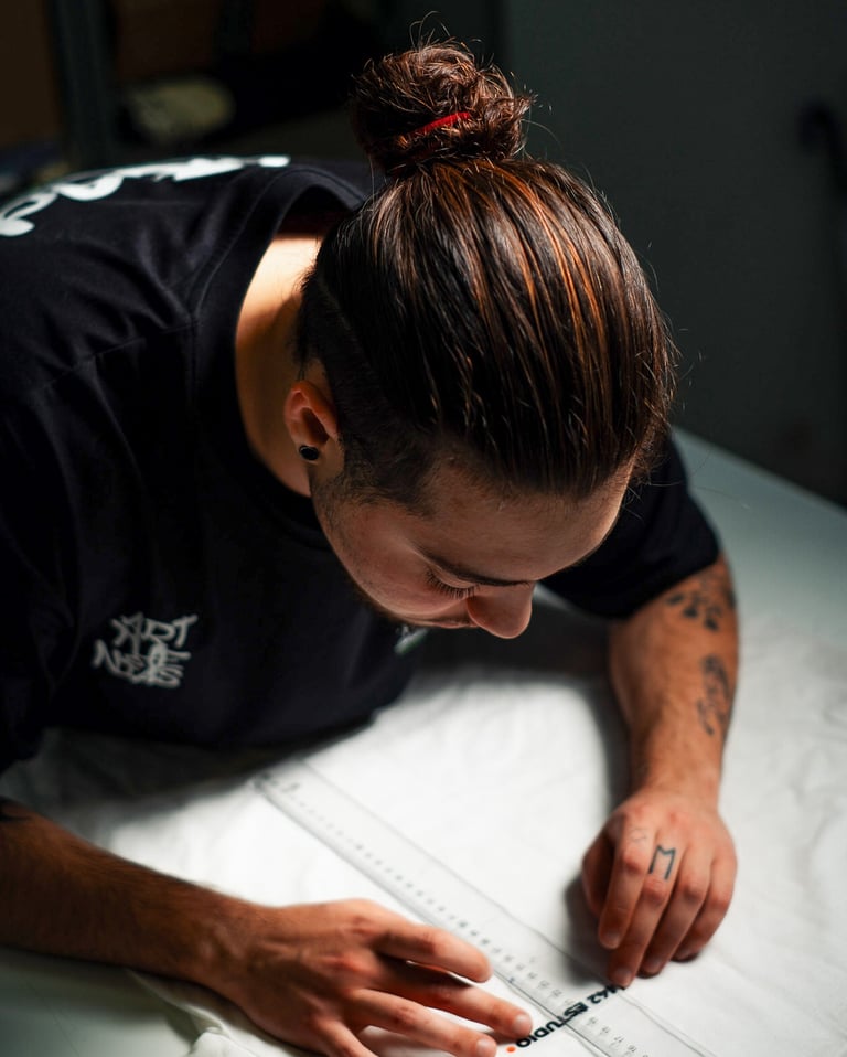 a man is looking down at a white sheet of paper