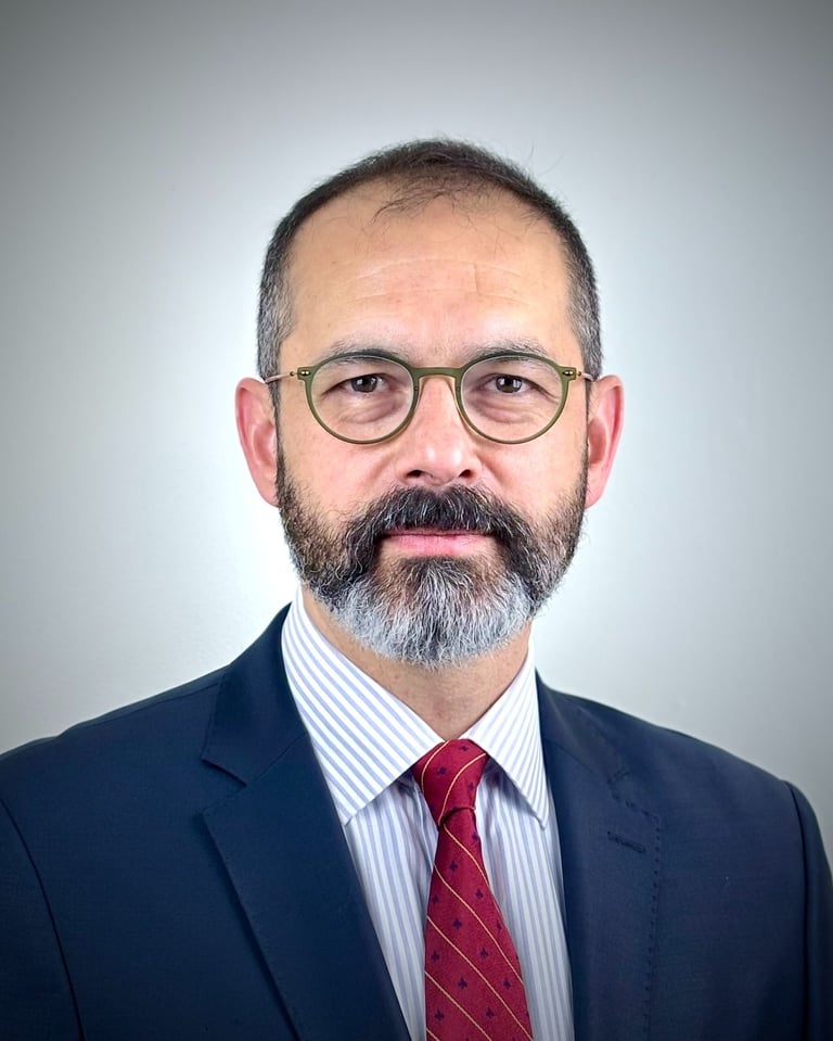 a man with a beard and glasses on a white background