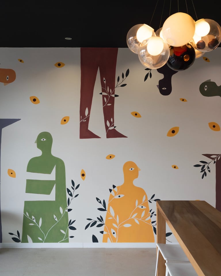 a wall mural of a woman sitting on a bench