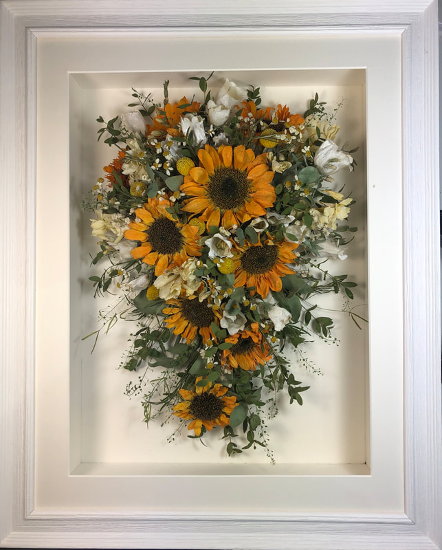 trailing view preserved wedding bouquet with sunflowers in a frame