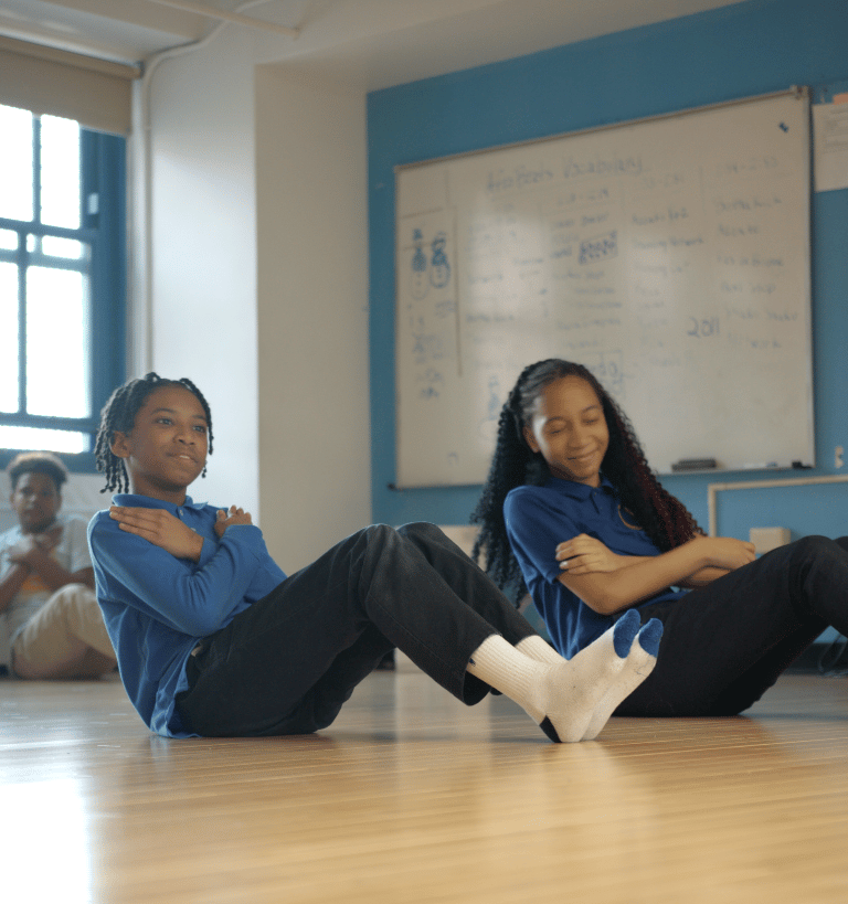 Students doing an abdominal exercise.