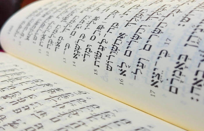 a book opened to show a book with hebrew writing