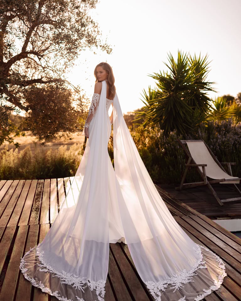a woman in a wedding dress standing on a deck