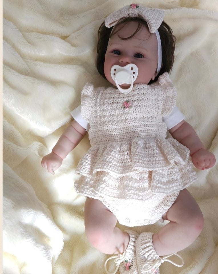 a baby girl wearing a white dress and pacifier pacifier pacifier pacifier