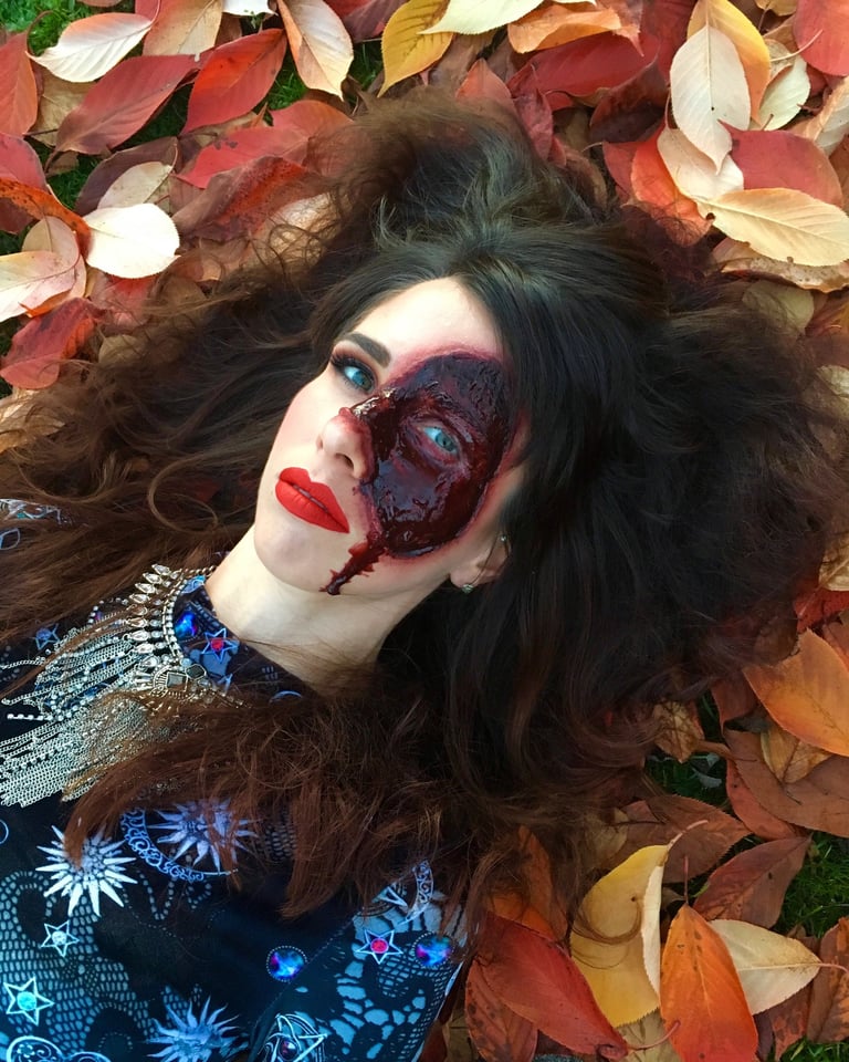a woman with a bloody face created with special effects makeup