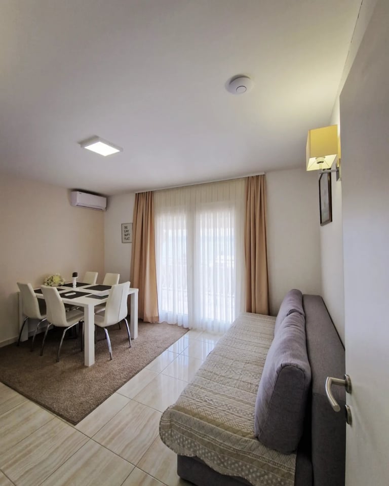 dining room with chairs and couch and windows
