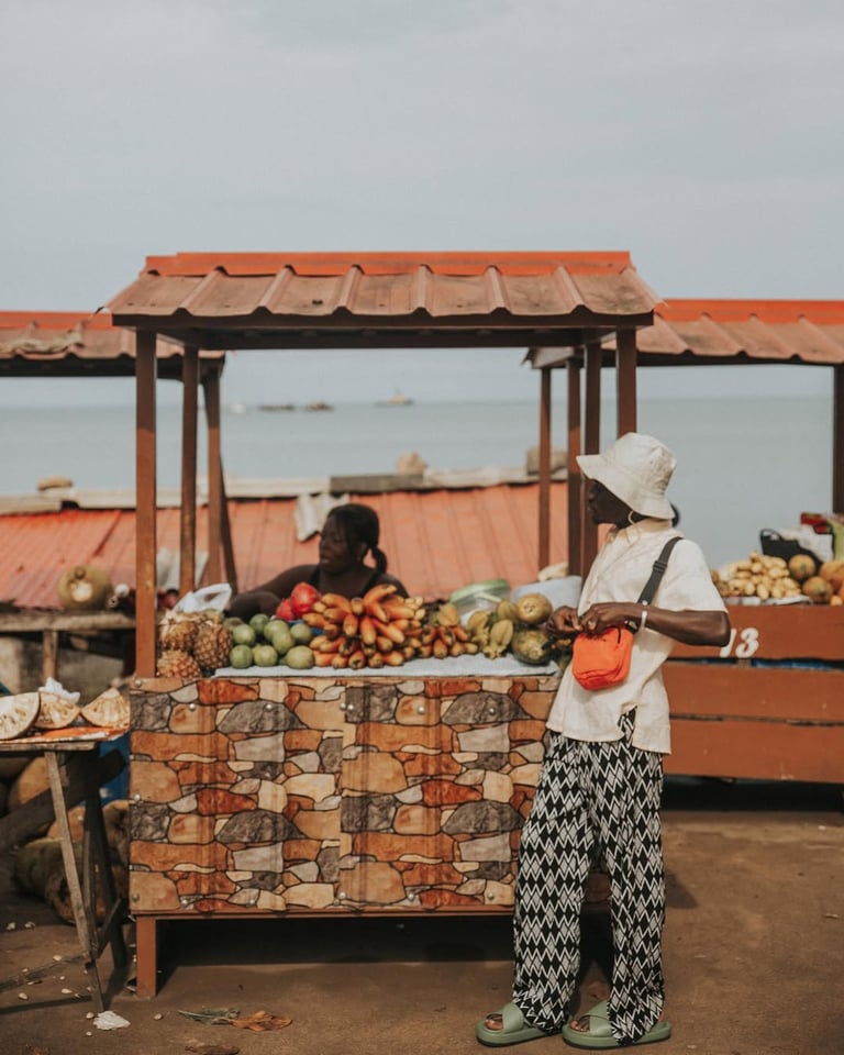 Kofi Dotse standing by a fruit shed in Sao Tome