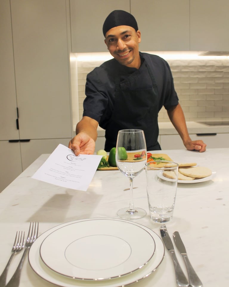 a man in a chef's uniform is holding a piece of paper