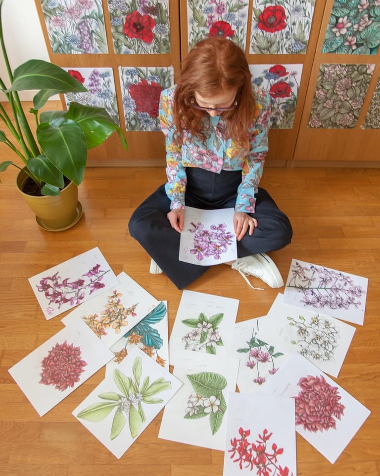 A woman sat on the floor surrounded by floral illustrations