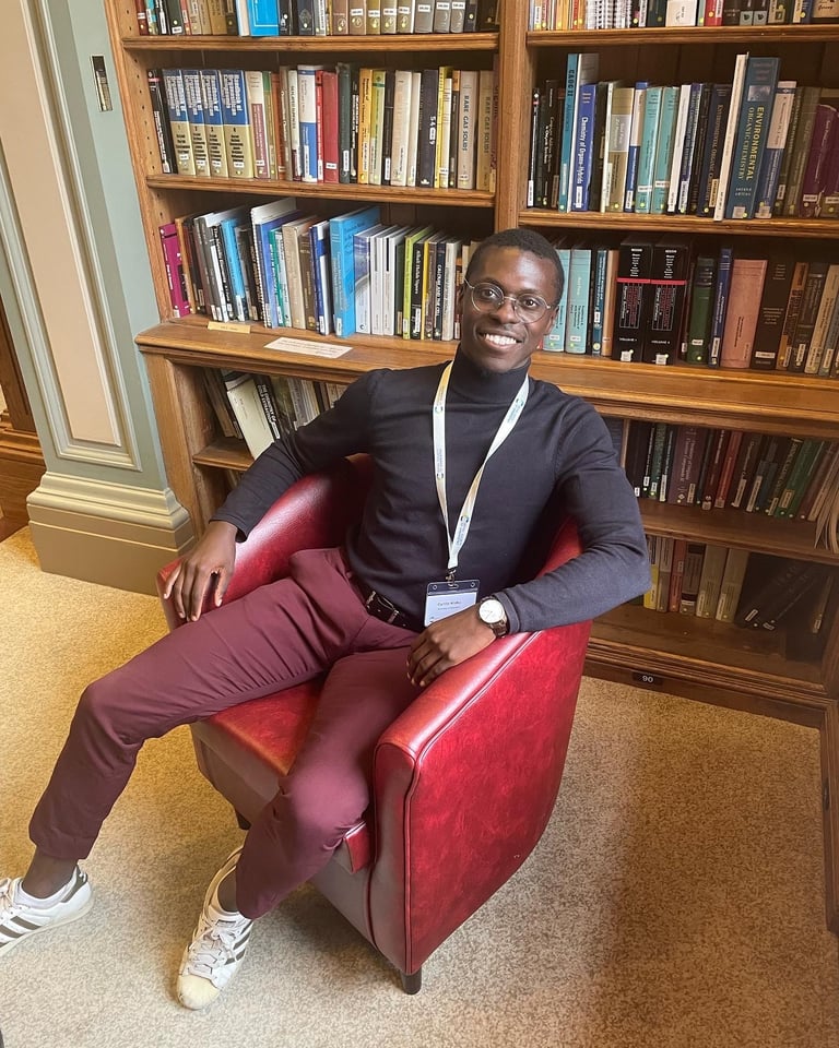 a man sitting in a chair in a library