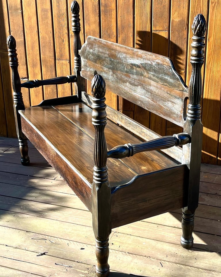 Wood bench created from a weathered antique bed frame.