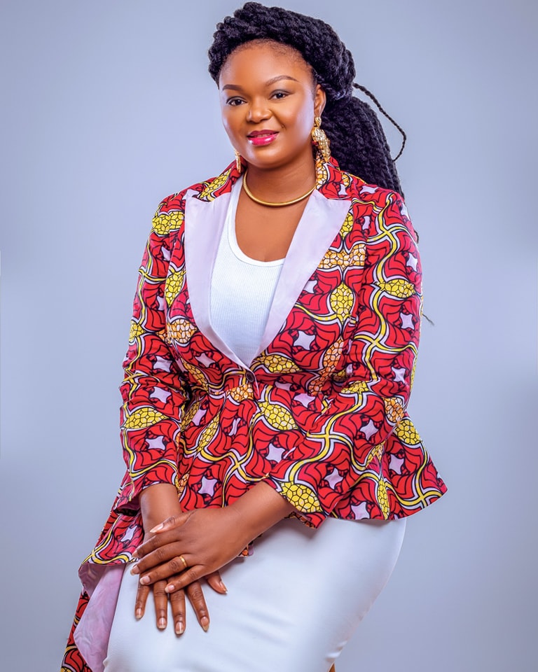 a woman in a red jacket and white top