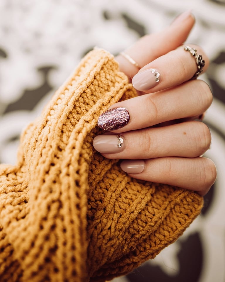a woman's hand holding a gold ring