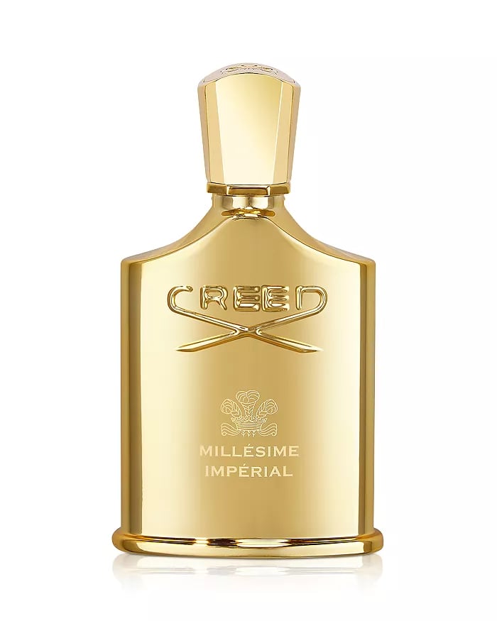 Luxurious gold Creed Millésime Impérial fragrance bottle with an elegant embossed logo.