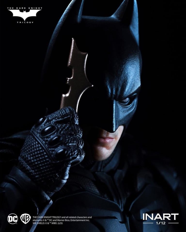 Primer plano de Batman de The Dark Knight sosteniendo un batarang en una pose de acción