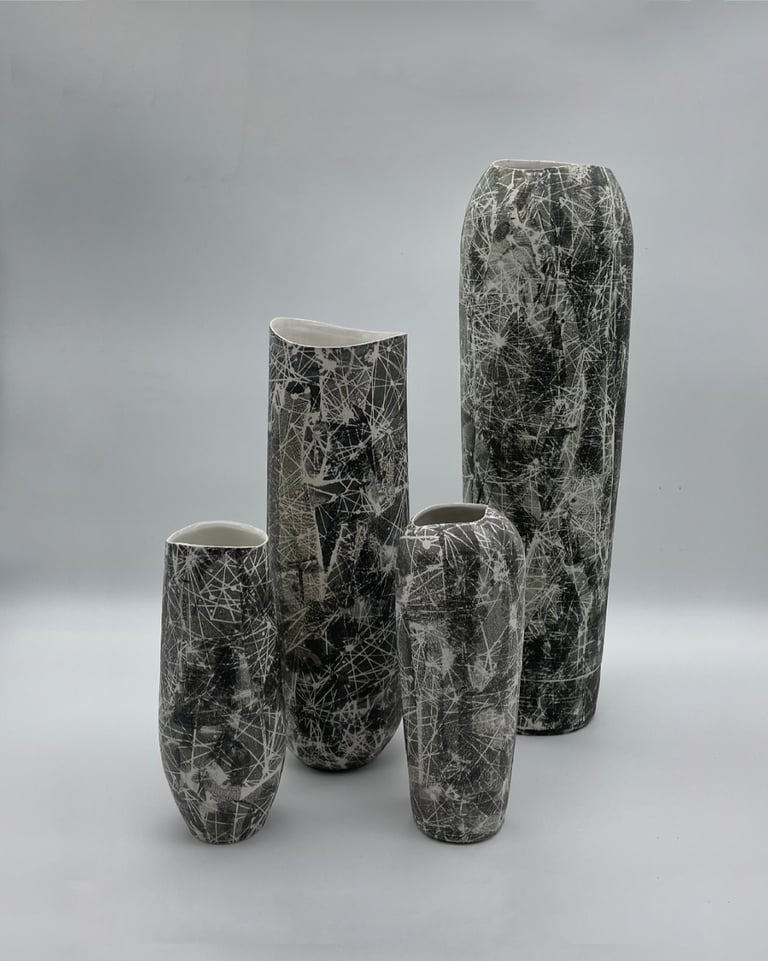 4 tall vases with black and white constellation patterns on the surface