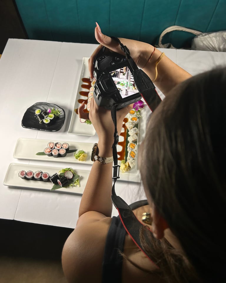 a woman is taking a picture of a sushi