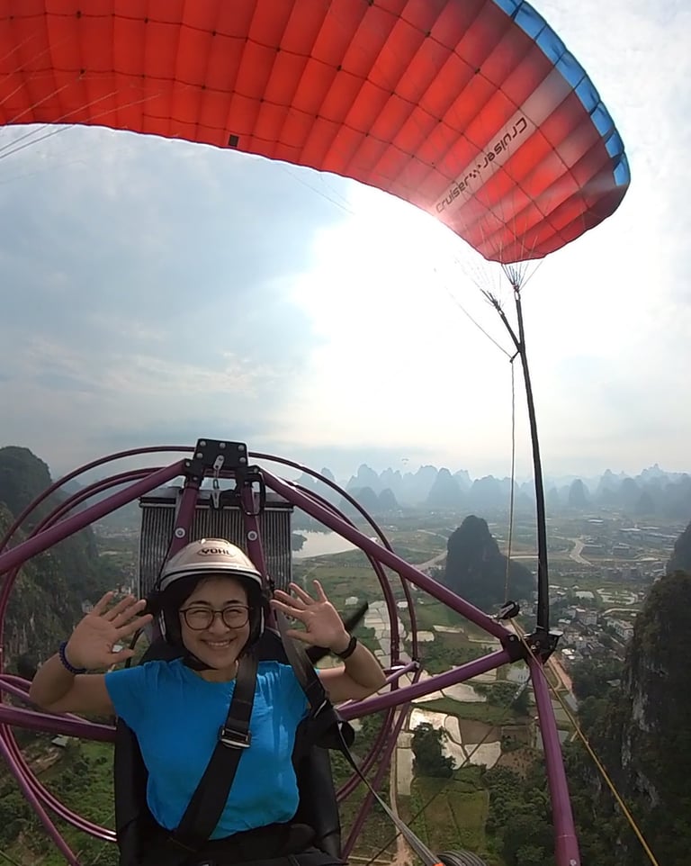 a woman in a blue shirt is parasailing