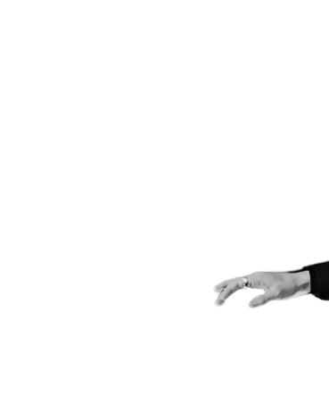 a man in a suit and shoes standing in front of a black background