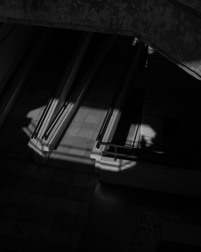 Black and white architectural photography with dramatic shadows and geometric lighting Unseen Spaces