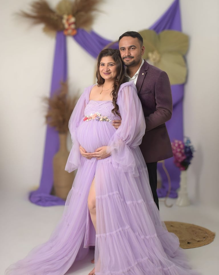 Expectant parents sharing a moment during a professional maternity studio session